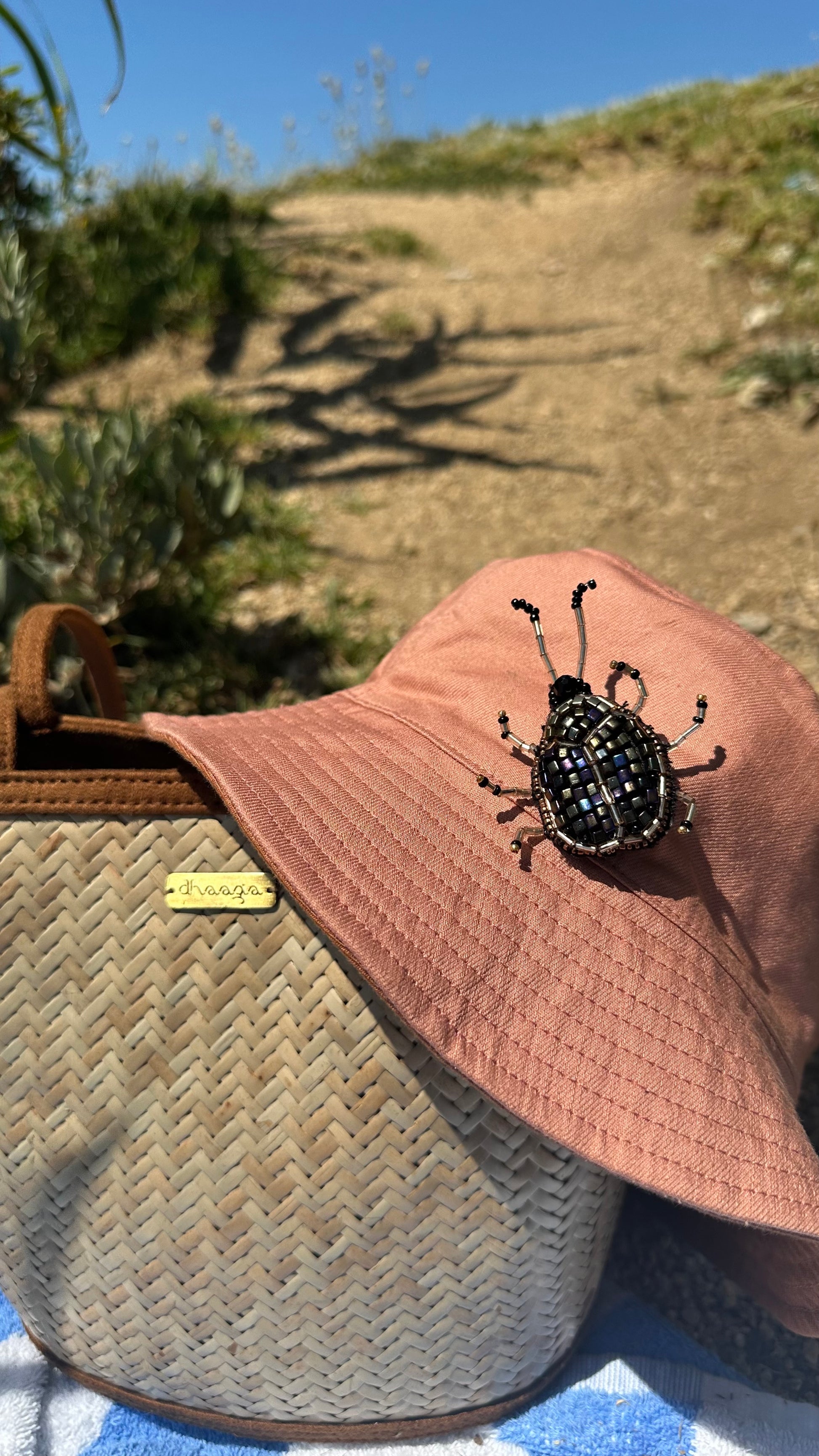 Reversible bucket hat with a beetle insect 